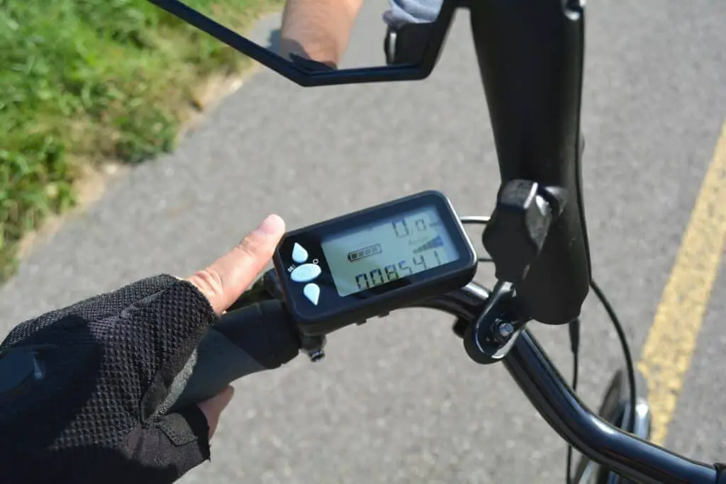 Display on a bike handle showing mileage, speed, battery charge and other detials.