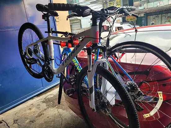 Trunk mounted bikes on a red car